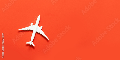 Travel concept. Airplane model, airplane on a bright red background.