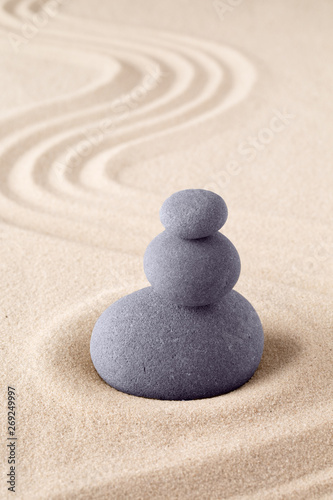 Stone stack, Japanese zen sand garden with pile of rocks. Concept for balance and purity.
