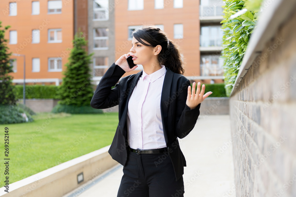 Fototapeta premium Productivity outside the office, young business woman working outdoor