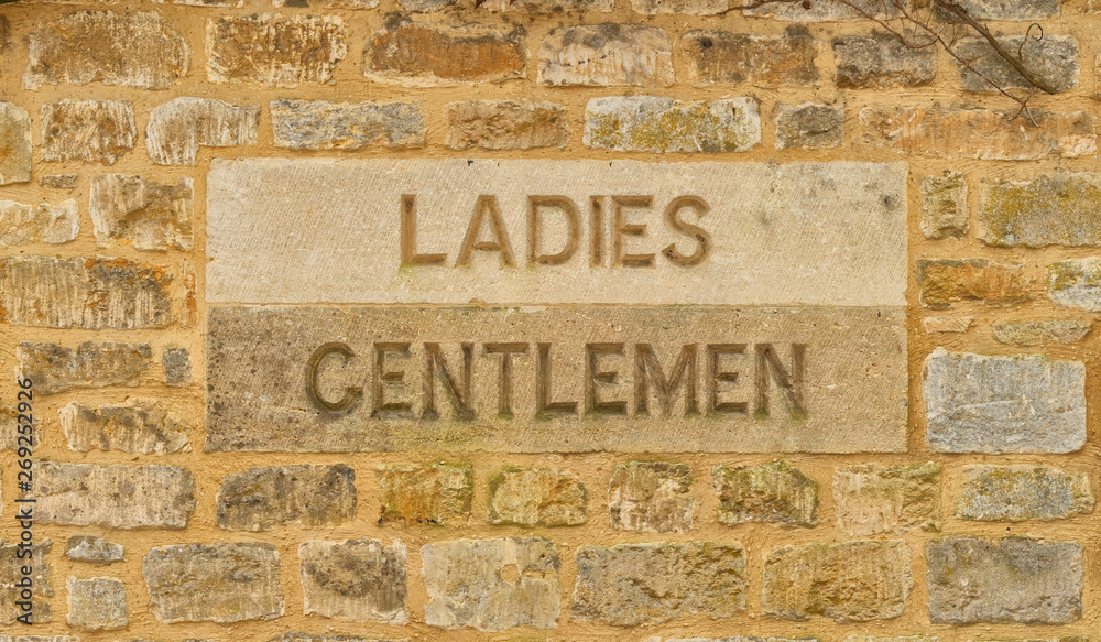 Ladies and Gentlemen sign carved in stone, The Cotswolds United Kingdom
