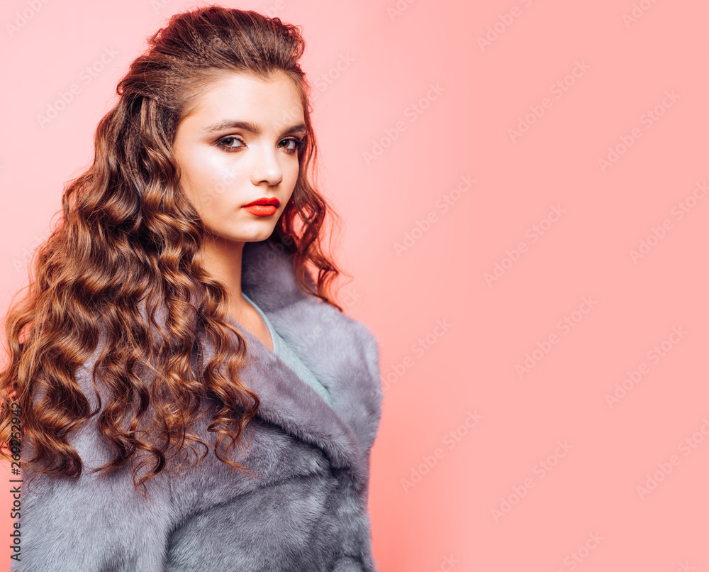 Healthy hair care habits. Teenage girl with stylish wavy hairstyle. Pretty  girl with curly hairstyle. Young woman with long locks of hair. Hair styling  in beauty salon. Smooth curls, copy space Stock