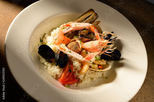 Rice with seafood on a plate in restauant ready to be served photo