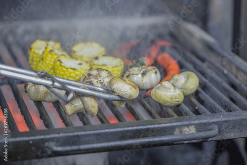 Natural organic vegetables pepper, corn and mushrooms cooked on the grill for a party
