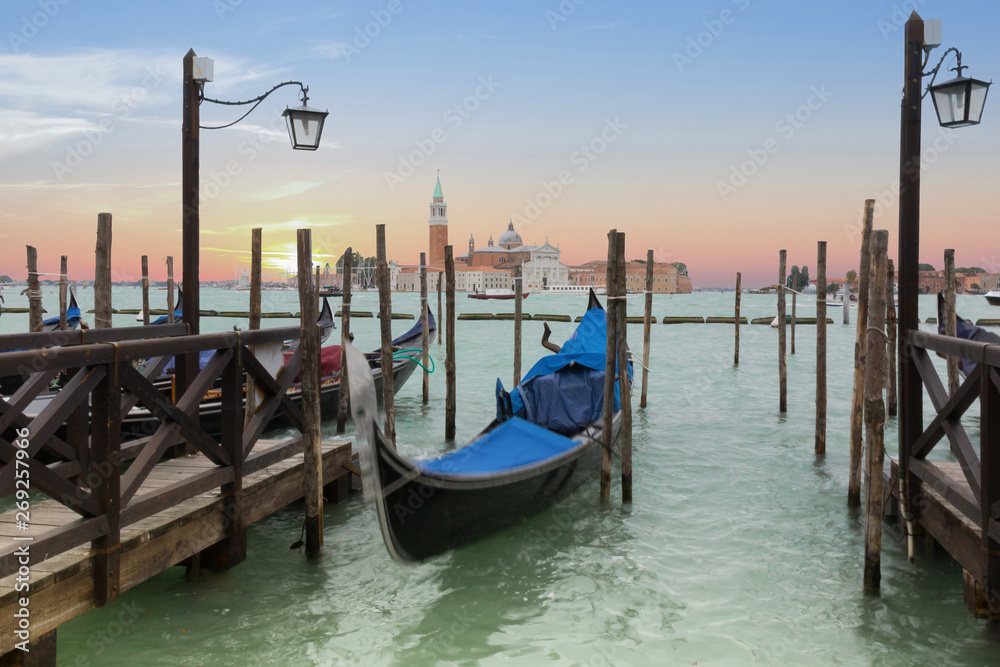 Venetian gondolas in canal in evening time