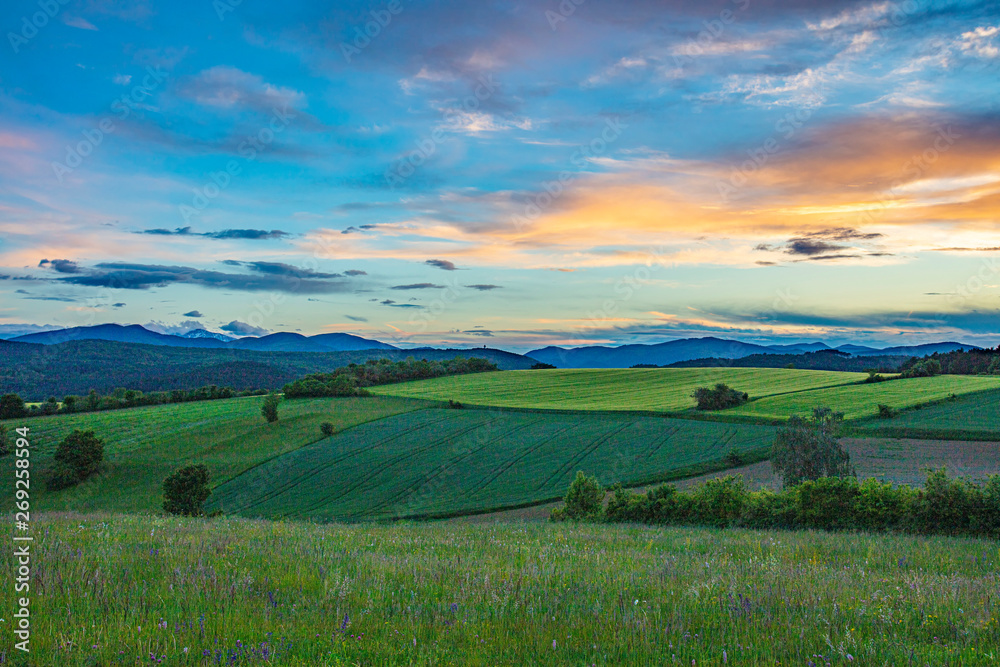 green hills and sunset sky 