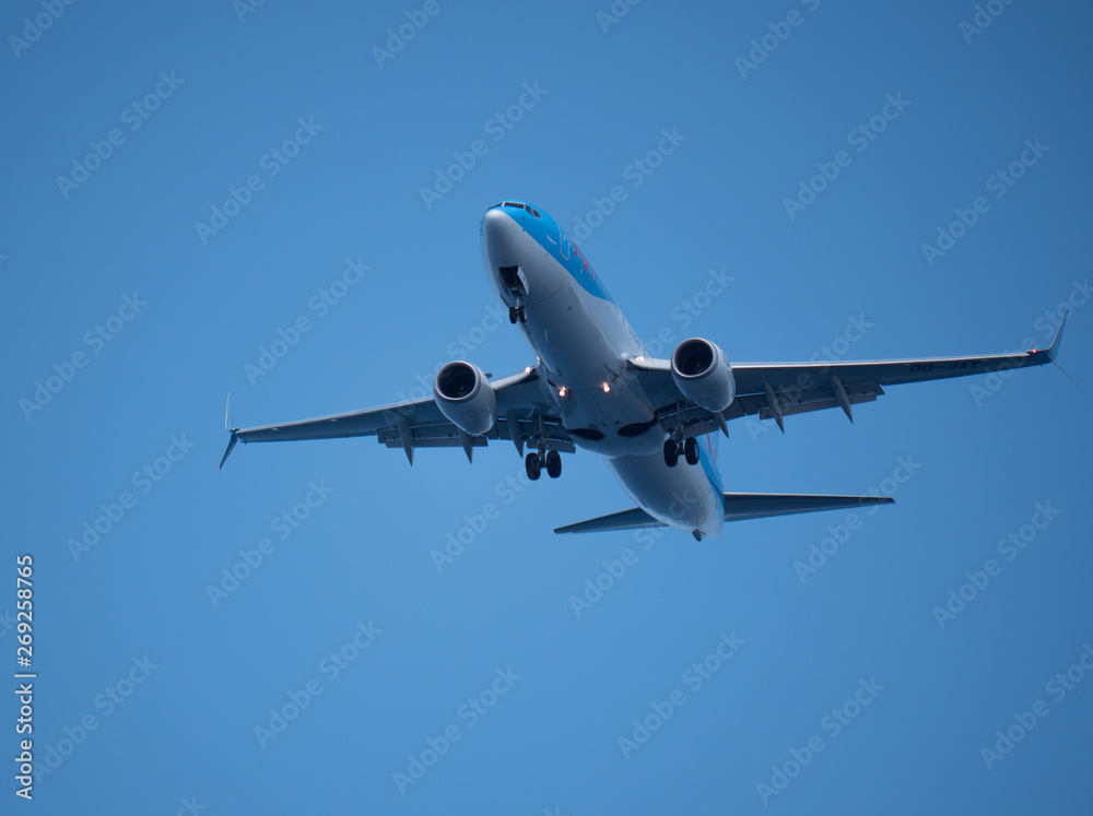 Big passenger airplane flying in blue sky