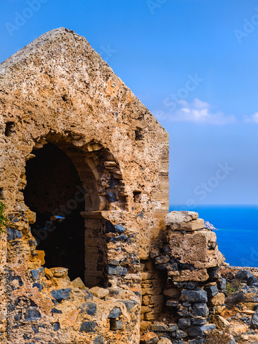 Ancient temple ruins atop the hill - sea and clear skies in the background