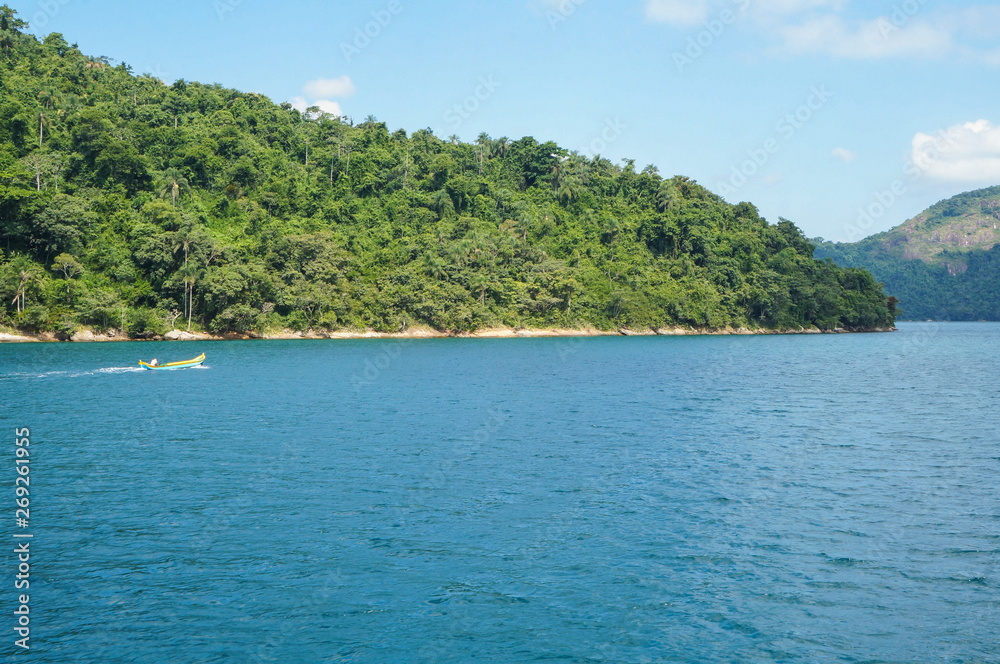  Man in a canoe at islands in Paraty, Rio de Janeiro, Brazil