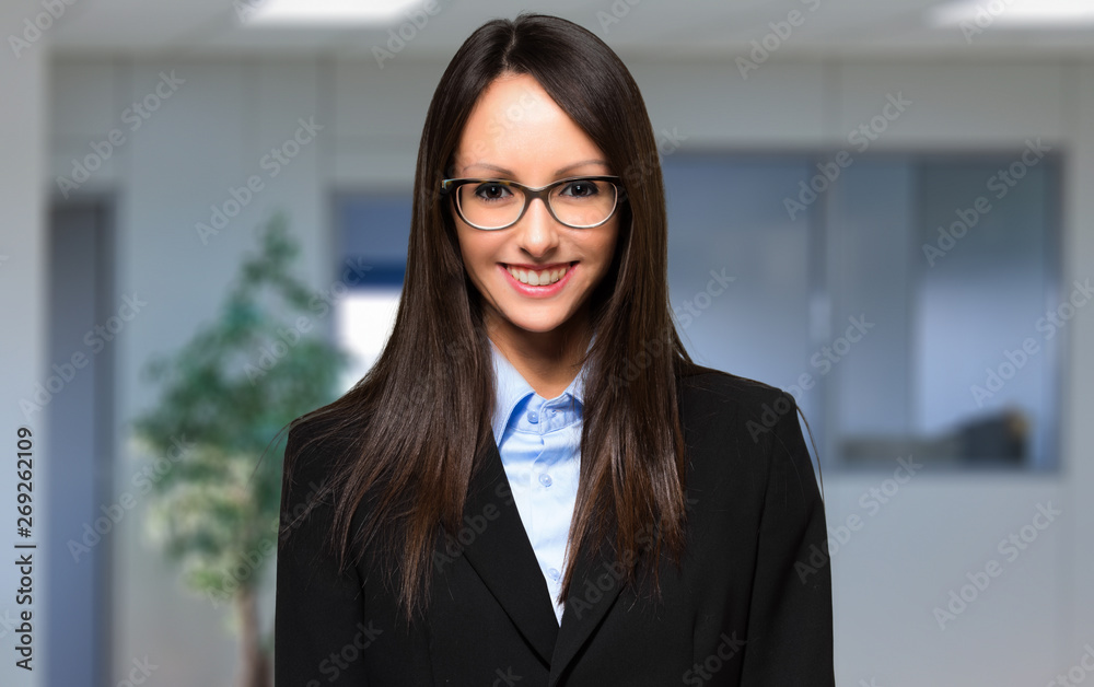 Smiling businesswoman portrait in a modern office Smiling businesswoman portrait in a modern office