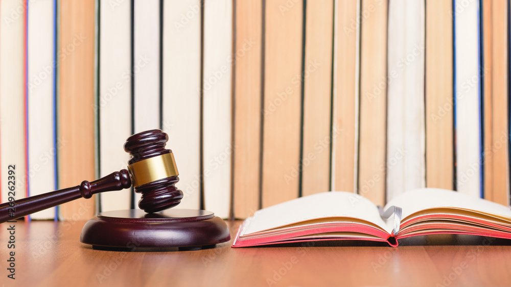 Law books, judge gavel, legal code on judge's wooden table. Сourt hearing. Judge’s verdict. Symbol law. Constitutional court. Law books, judge gavel, legal code on judge's wooden table. Сourt hearing. Judge’s verdict. Symbol law. Constitutional court.