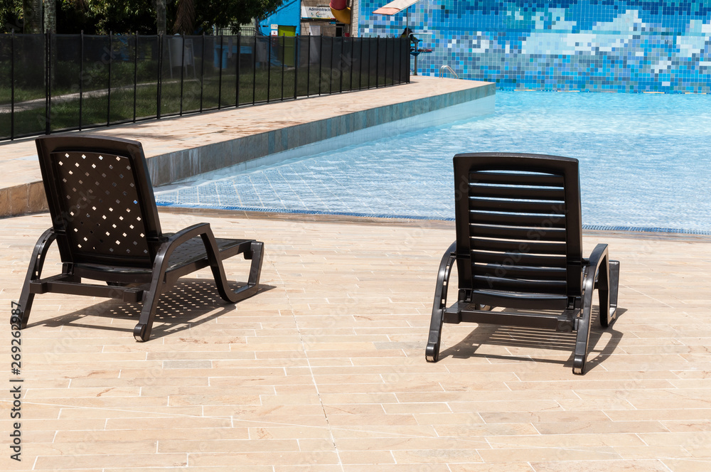 pool chairs by the pool on a sunny day pool chairs by the pool on a sunny day