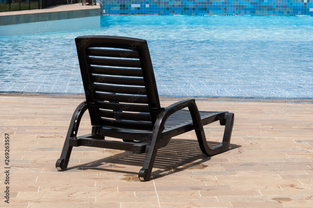 pool chair by the pool on a sunny day pool chair by the pool on a sunny day