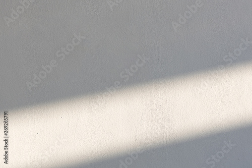 simplicity empty white cement wall with line of sun light and shadow at afternoon. used for template, background or texture.