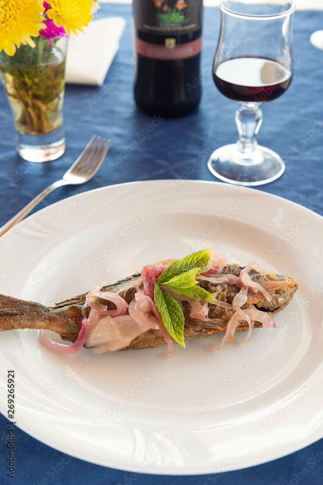 sea bass with onion and mint typical dish of the Aeolian islands in Sicily sea bass with onion and mint typical dish of the Aeolian islands in Sicily