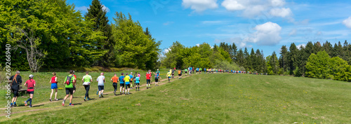 People trailrunning in beautiful mountain landscape panorama  photo