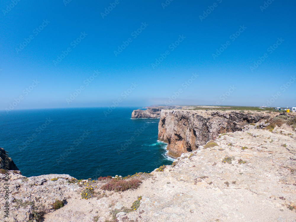 Praya de Marinha most beautiful beach in Algarve, Portugal. Cliffs on Coast of Atlantic ocean against blue sky  