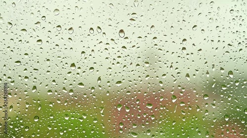 Rain drops on a window on a rainy day photo