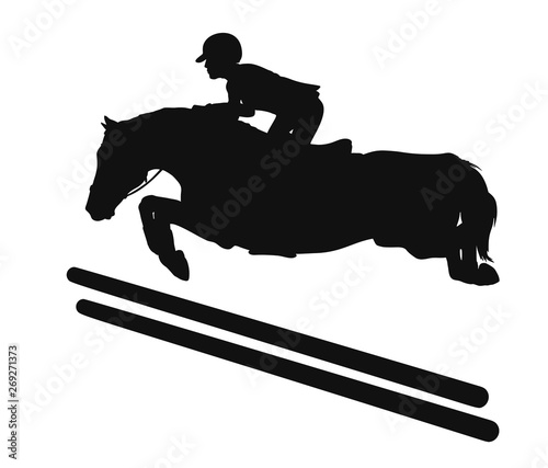 Silhouette of a rider and a horse jumping over an obstacle