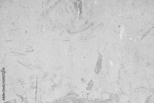 Graue Betonwand, Grauer Hintergrund, verputzte Wand mit markanten Strukturen und Mustern.