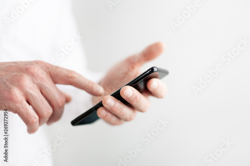 Hands of a man using his smartphone