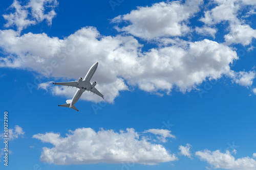 Commerical airplane in flight with clouds