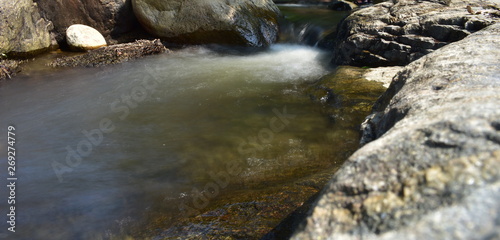 Kumbakkarai Water Falls and the Pambar river flows along the rocks photo