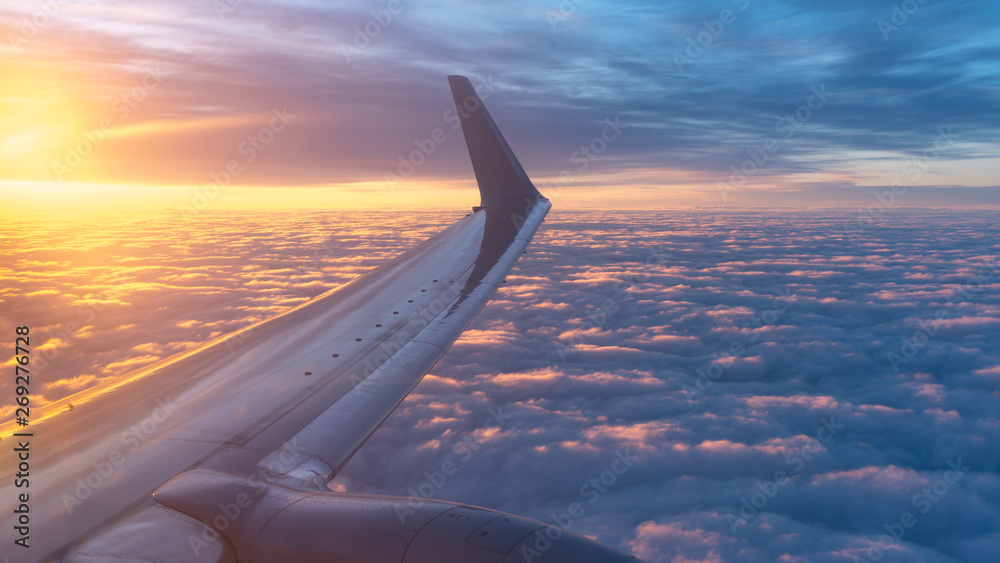 Beautiful salmon dawn and the wing of an airplane above the clouds. Beautiful salmon dawn and the wing of an airplane above the clouds.