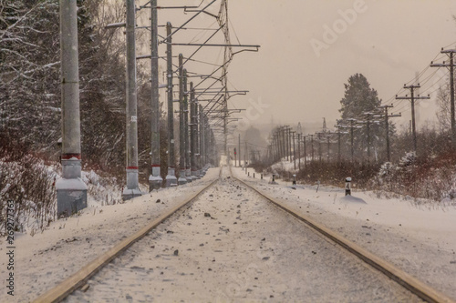 Russian railway in winter. Snow railway. Rails and sleepers.