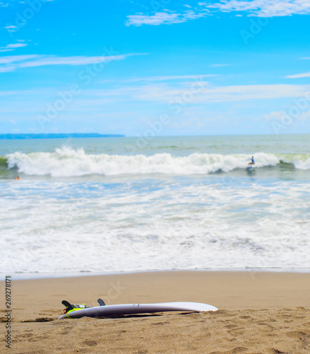 Surfboard on sandy beach