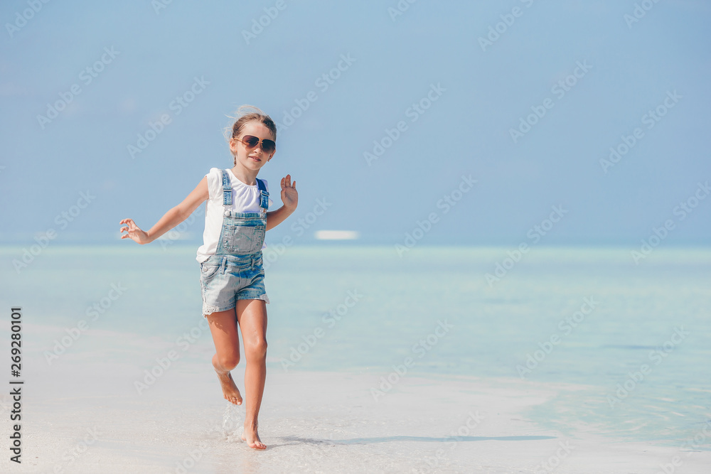 Adorable little girl at beach during summer vacation Adorable little girl at beach during summer vacation