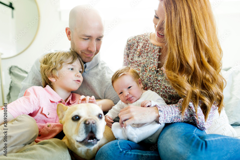 Family and their dog on bed Family and their dog on bed