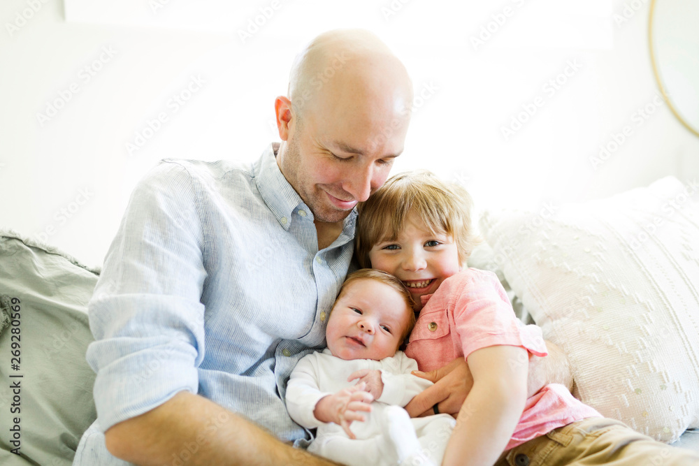 Man with his sons on sofa Man with his sons on sofa