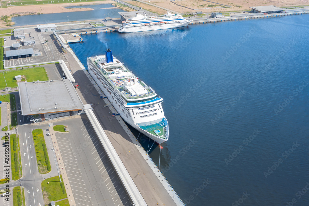 Passenger port with two cruise liners, preparing for departure on a trip.