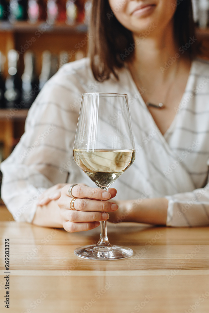 Woman holding glass of white wine Woman holding glass of white wine