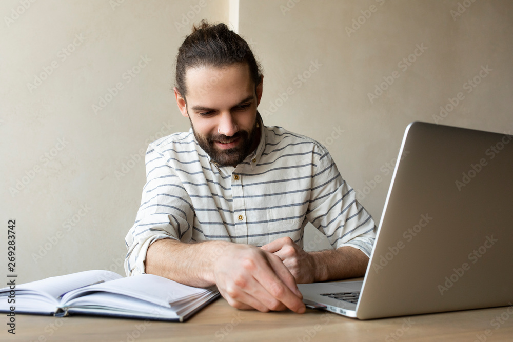 Young businessman putting USB stick into laptop Young businessman putting USB stick into laptop