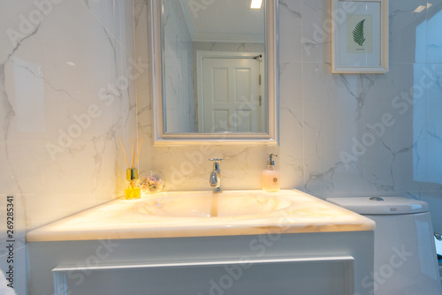 Condo bathroom design with single vanity cabinet and grey tiles on the walls.