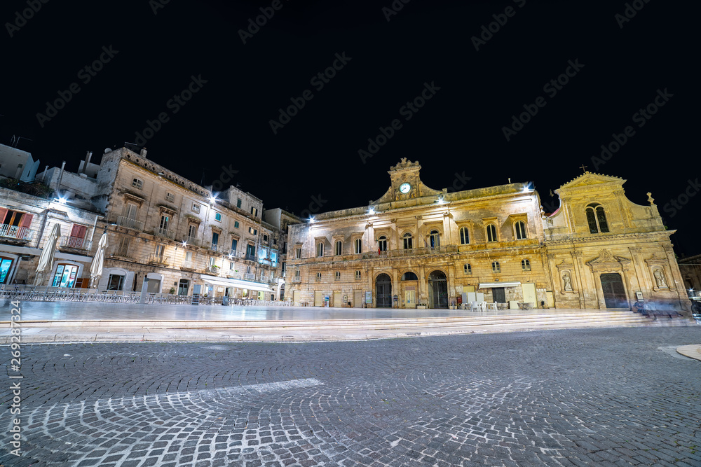 The main square of Ostuni (Piazza della Liberta square). White city in Apulia at night