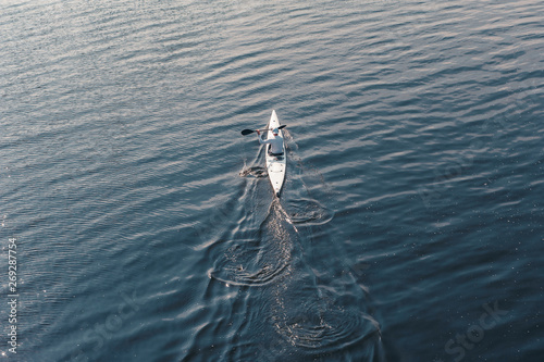 Fast movement of athletic male oarsman on sea water © serguastock