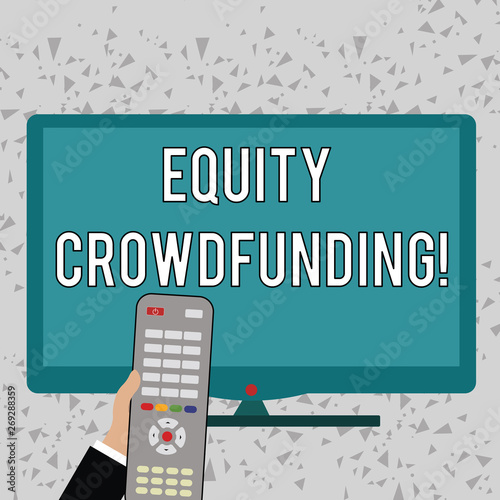 Word writing text Equity Crowdfunding. Business photo showcasing raising capital used by startups and earlystage company Hand Holding Computer Remote Control infront of Blank Wide Color PC Screen photo