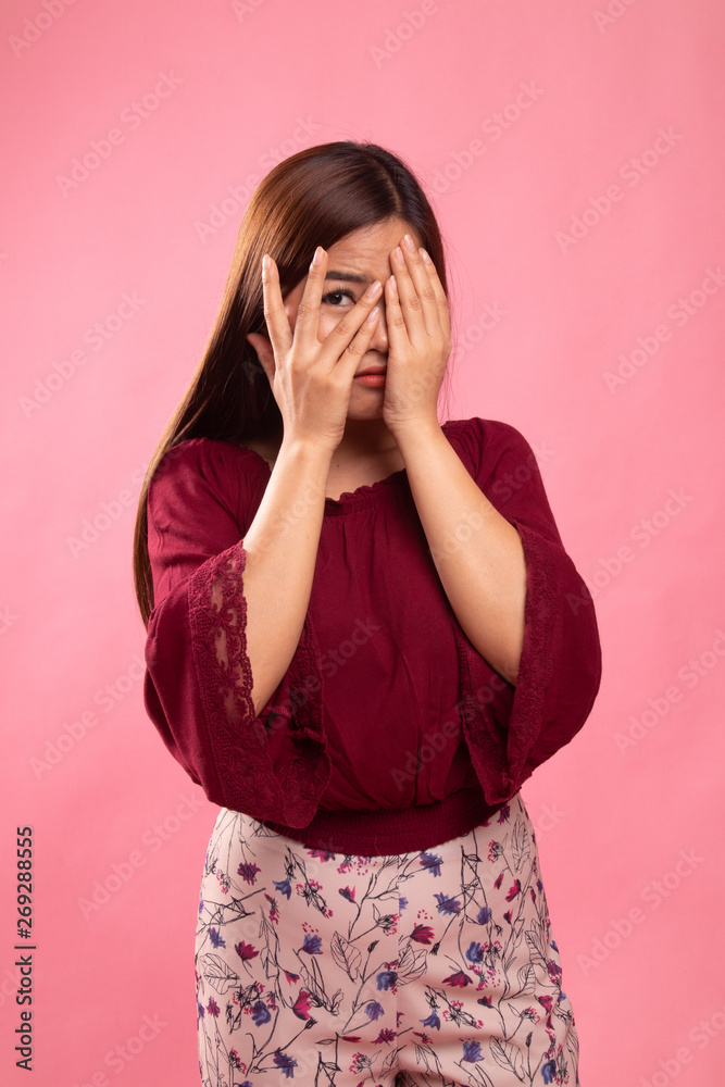 Beautiful young Asian woman peeking through fingers. Beautiful young Asian woman peeking through fingers.