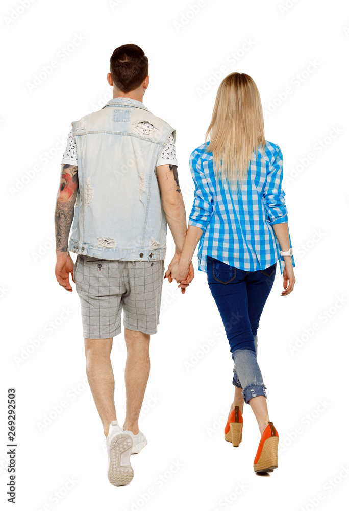 Back view of going couple. walking friendly girl and guy holding hands. Back view of going couple. walking friendly girl and guy holding hands.