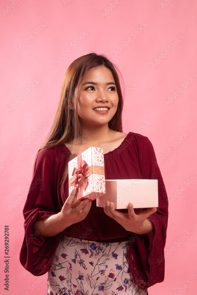 Young Asian woman open a gift box. Young Asian woman open a gift box.
