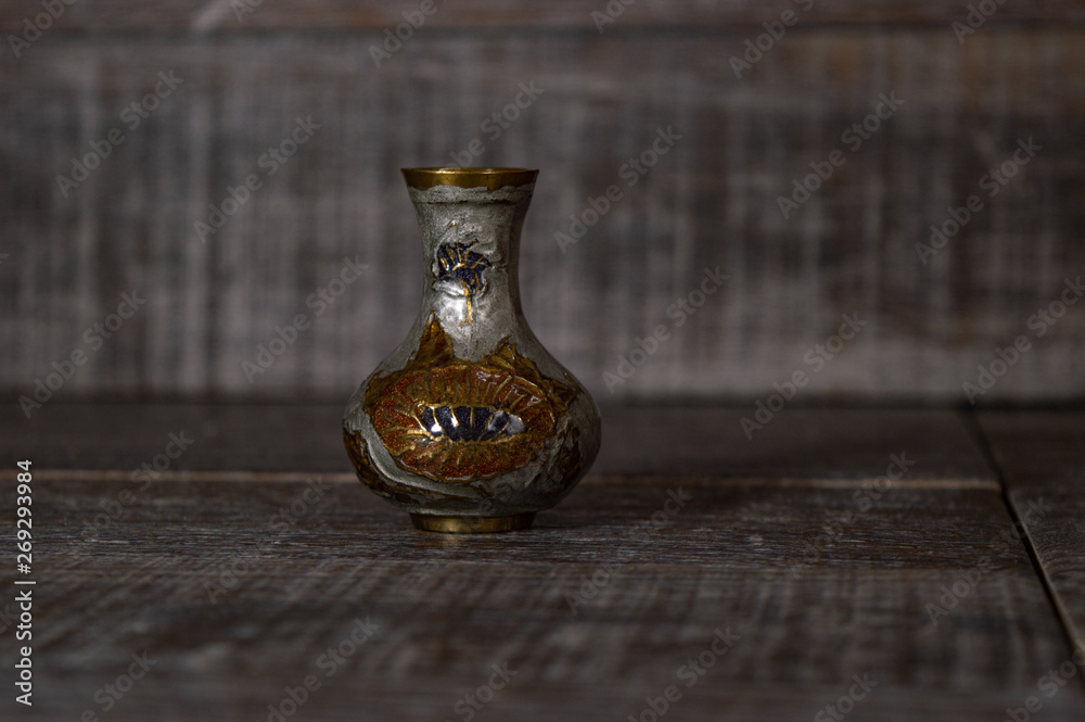 Artistic ancient pottery vase isolated on a dark grey background used for decoration.