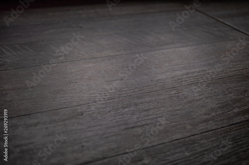 Dark grey background with wooden texture suitable for interior design. © Josif