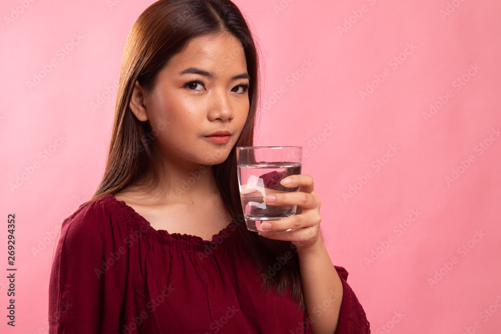 Young Asian woman with a glass of drinking water. Young Asian woman with a glass of drinking water.