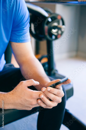 join a gym with a phone application. Man using technology to keep track of calories and exercises