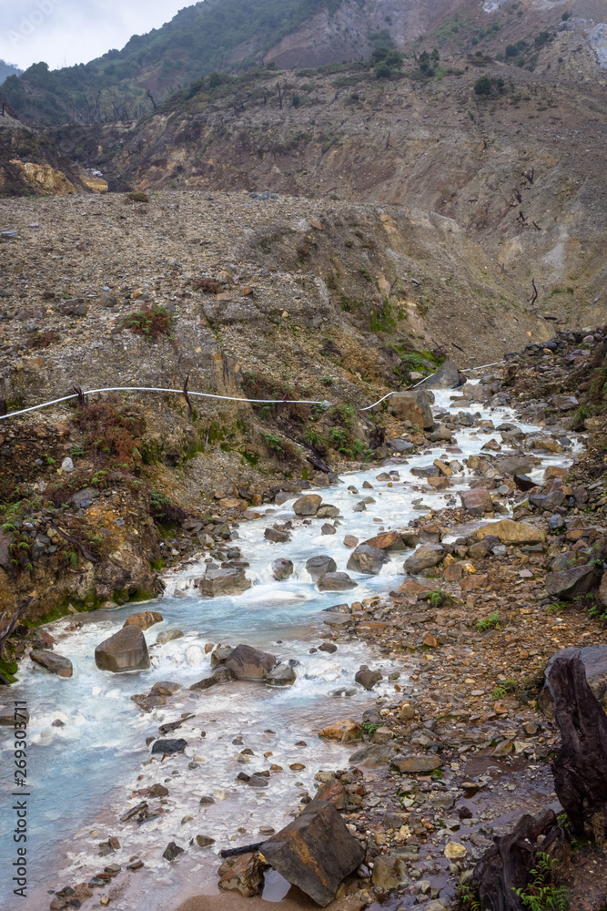 Rocky stream with white water on a mountain. Beautiful landscape of mount Papandayan. Papandayan Mountain is one of the favorite place to hike on Garut. Rocky stream with white water on a mountain. Beautiful landscape of mount Papandayan. Papandayan Mountain is one of the favorite place to hike on Garut.