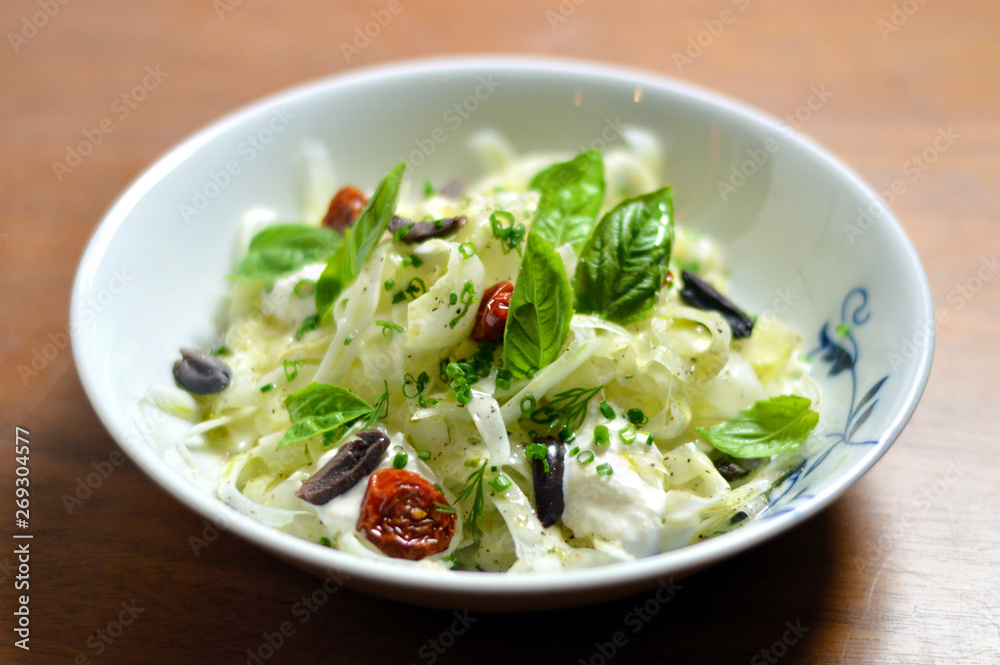 Delicious gourmet green fresh fennel salad with sun dried tomatoes and olives Delicious gourmet green fresh fennel salad with sun dried tomatoes and olives