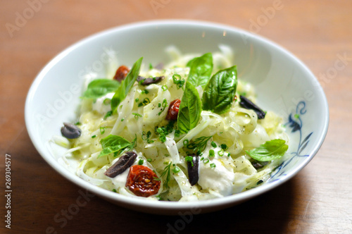 Delicious gourmet green fresh fennel salad with sun dried tomatoes and olives