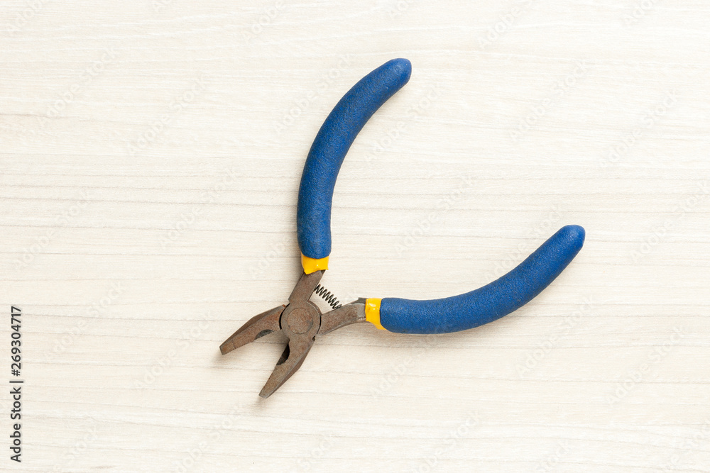 pliers at wooden background. top view. pliers at wooden background. top view.